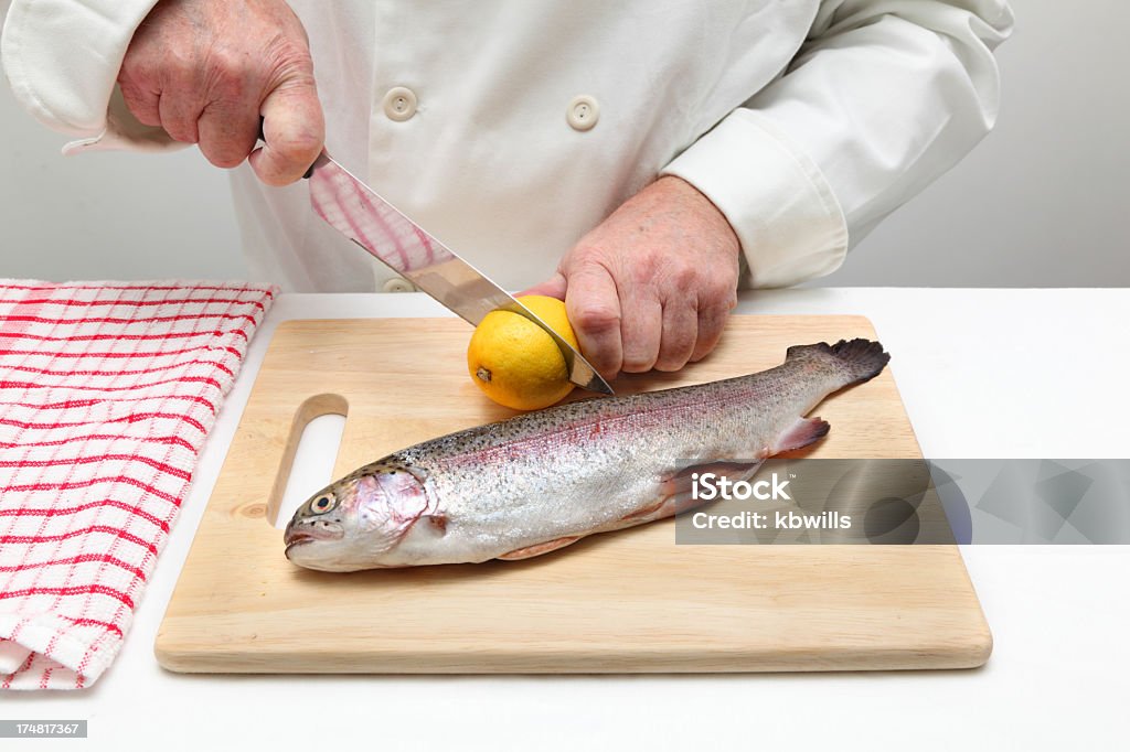 El chef prepara limones antes de pescado filleting trucha arco iris - Foto de stock de Agarrar libre de derechos