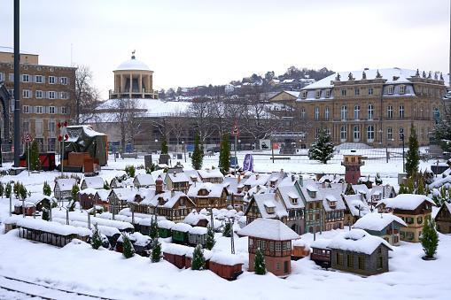 Model train at Christmas market in the city. Landscape with train and small houses with snow. Germany, Stuttgart.