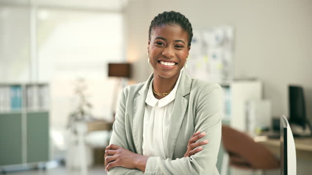 Face, business and happy black woman with arms crossed in office, corporate workplace and company. Portrait, smile and confidence of professional African lawyer, employee and consultant in Nigeria