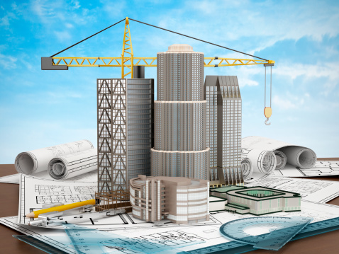 Buildings and construction crane standing on plans with ruler sets.Similar images:
