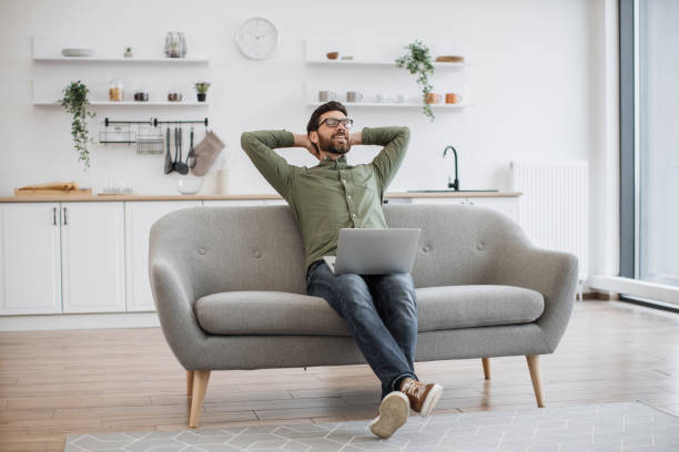 istock Male freelancer resting on couch with modern laptop 1748177797