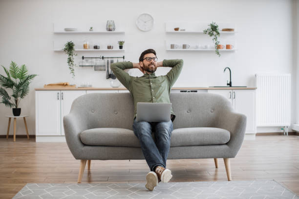 istock Male freelancer resting on couch with modern laptop 1748177989