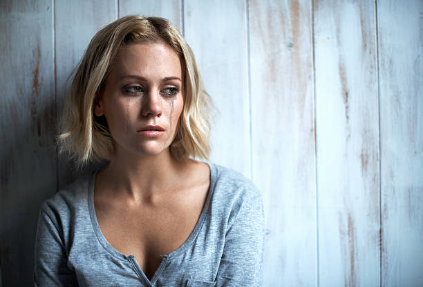 Living in memories of sadness A pretty young blonde woman with mascara tears running down her face woman mascara smudged stock pictures, royalty-free photos & images