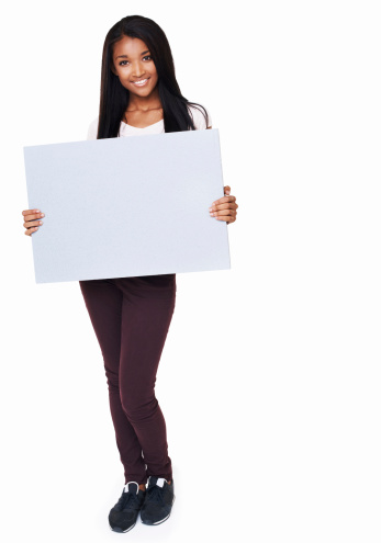 Full length portrait of an young african american girl holding up a blank sign isolated on white