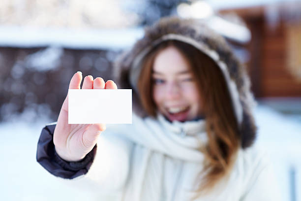 istock Winter. Girl with blank visiting card. 174818233