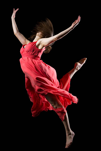 istock The dancer in midair on black 174818389