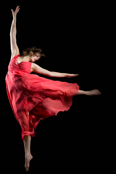 istock The dancer in midair on black 174818423