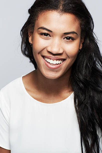 istock Young woman smiling against white background 174818529