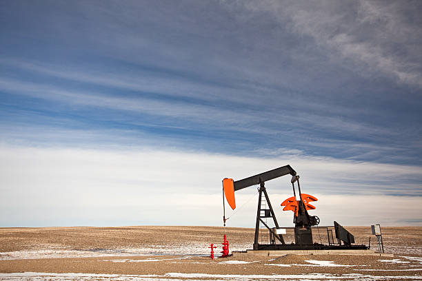 Pumpjack on the Prairie A red pumpjack on the prairie. oil pump oil industry alberta equipment stock pictures, royalty-free photos & images