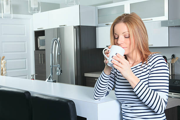 istock Kitchen - Young Woman Smell Tea 174819406
