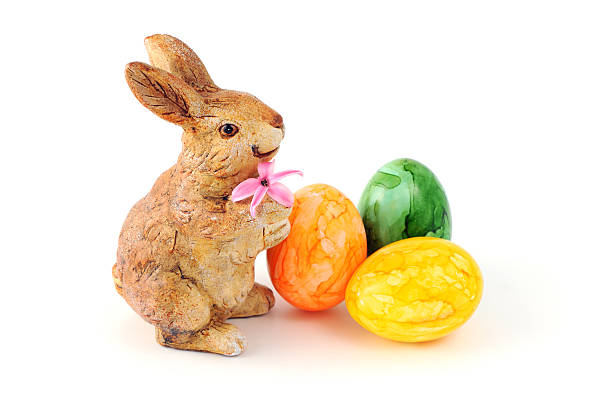 istock easter bunny pink Hyacinth and three eggs on white background 174819618