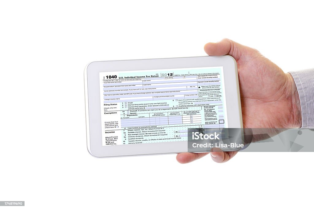 Tax Form on Digital Tablet Hand holding tablet with 1040 Tax form. Cut Out Stock Photo