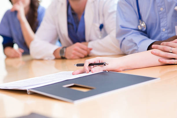 istock Medical team of doctors looking at patient chart or information 174819746