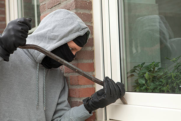 istock Burglar with crowbar trying to enter house, stealing valuables 174820006