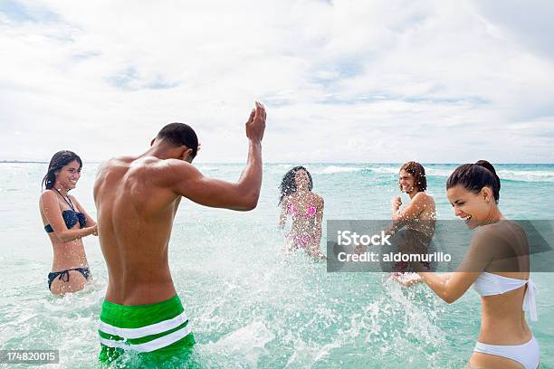 Happy Friends Splashing Water To Each Other Stock Photo - Download Image Now - 20-29 Years, Adult, African Ethnicity