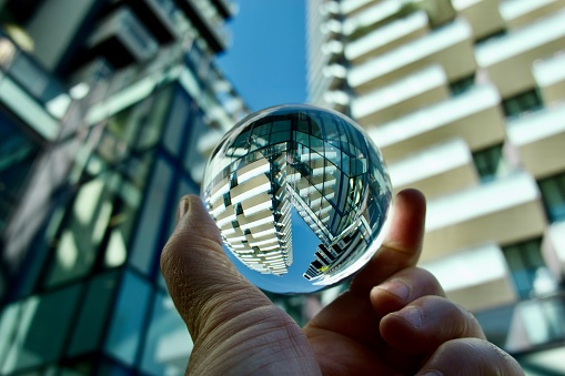 Crystal ball against city skyscrapers