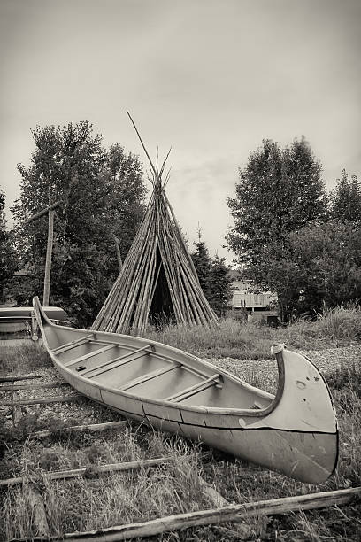 Teepee and Birch Bark Canoe stock photo