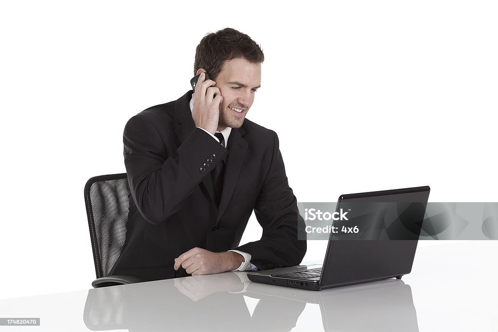 ビジネスマンを使用して、ノートパソコンや携帯電話で話している - 1人のロイヤリティフリーストックフォト
