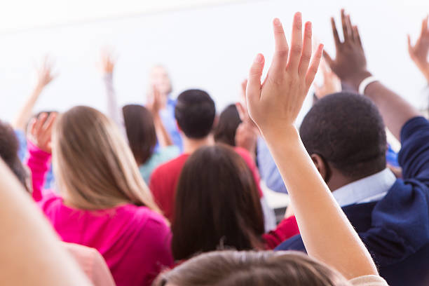 istock Diverse group of college students raising hands to answer question 174820583