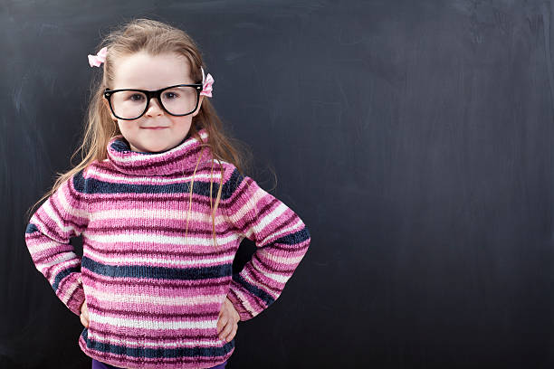 istock Cute girl in front of a chalkboard 174820636