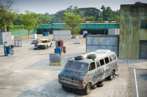 Old abandoned car in a paint ball court