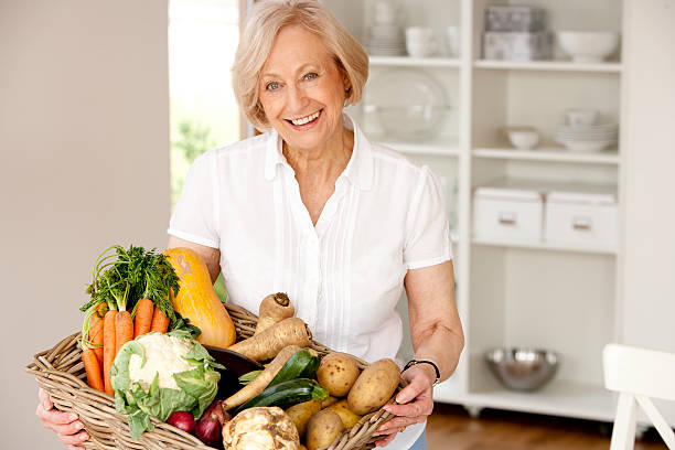 istock Mature woman with fresh vegetables 174820945