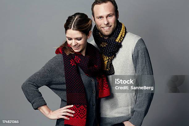 Portrait Of Mid Adult Couple Wearing Scarves Stock Photo - Download Image Now - Colored Background, Couple - Relationship, Smiling