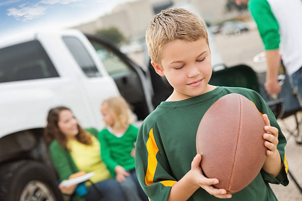 Little boy tailgating with family near football stadium Little boy tailgating with family near football stadium. people family tailgate party outdoors stock pictures, royalty-free photos & images