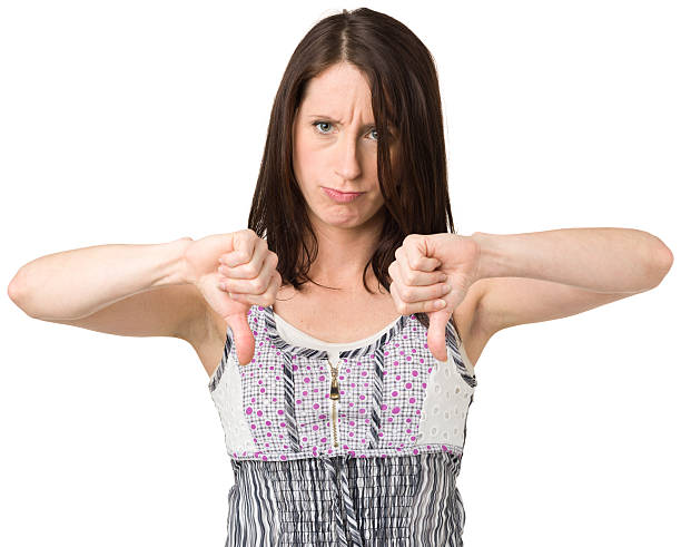 istock Annoyed Young Woman Gives Thumbs Down Gesture 174821415