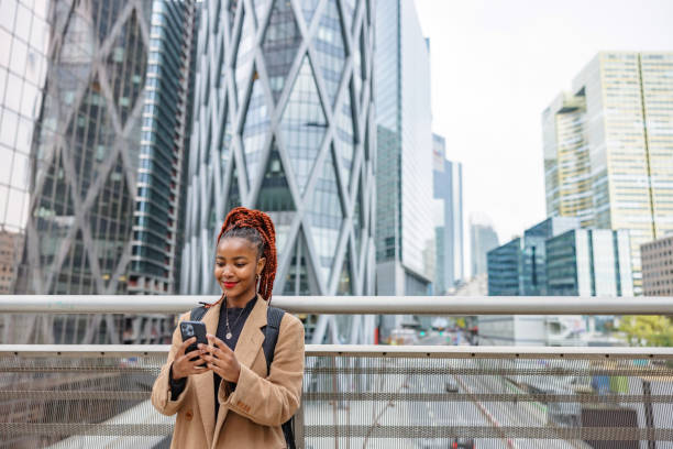 istock African Lady Standing On A Bridge Overlooking The Financial District 1748214589