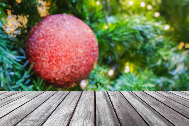 istock Empty wood table top with blur Christmas tree with bokeh light background 1748215113