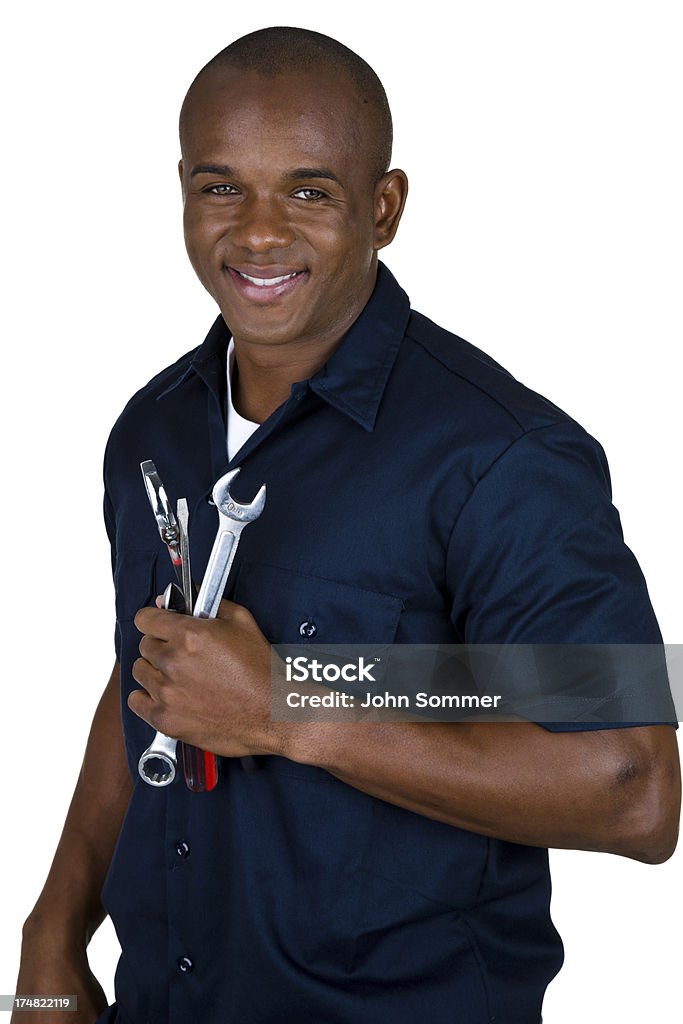 Cheerful mechanic Vertical composition of a mechanic with a trustworthy smile holding tools  Mechanic Stock Photo