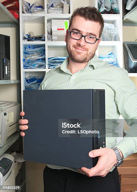 Electronics Engineer Holding Computer Stock Photo - Download Image Now - Adult, Adults Only, Broken