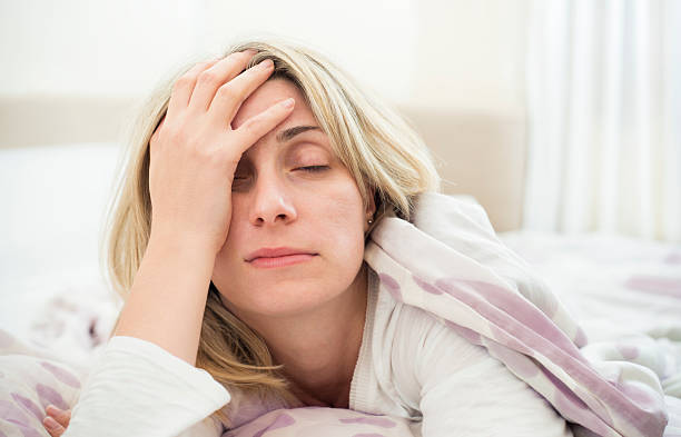 Sleeping problems "Woman having difficulties getting up in the morning. Horizontal framing, shallow depth of field used, adobeRGB photo." insomnia stock pictures, royalty-free photos & images