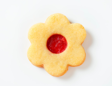 linz flower-shaped cookie with fruit jam on a white bacground