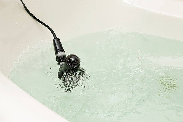 Electrical Danger Hair Dryer Falling Into Bathtub Stock Photo - Download  Image Now - Bathtub, Hair Dryer, Electricity - iStock