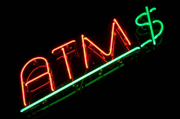 istock ATM Sign with Green Dollar Black Background 174823550
