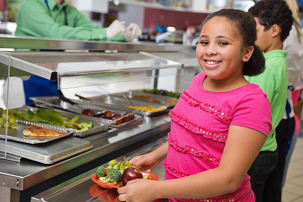 istock Elementary students making healthy choices in school lunch line 174823757