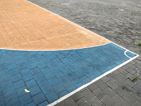 Top view of colorful outdoor basketball playground detail on paving blocks