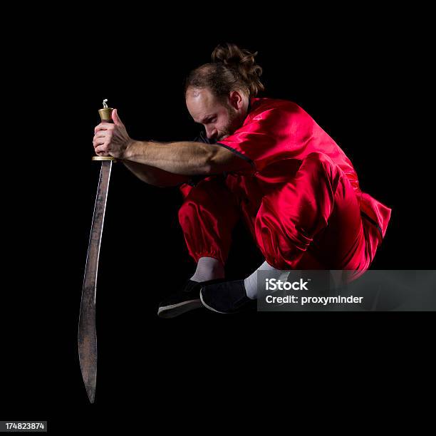 Shaolin Kung Fu Fighting Position With Dao Sword In Midair Stock Photo - Download Image Now