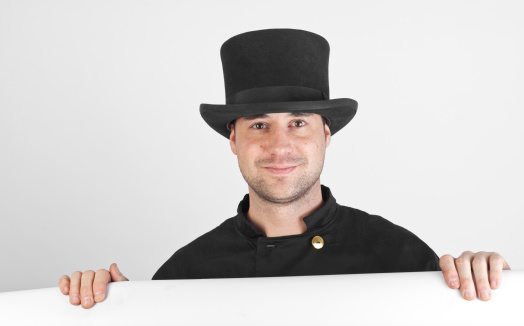 A young chimney sweep in front of a grey background