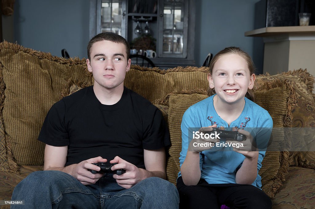 Young children playing video games on television Young children playing video games on television. 12-13 Years Stock Photo