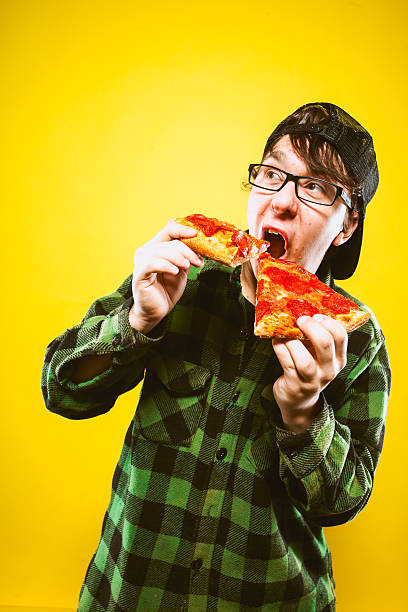 istock Double Pizza Eating Teenage Guy 174824947
