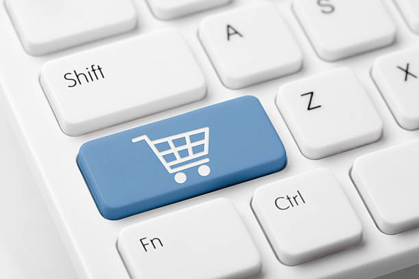 istock Shopping cart button on white keyboard 174825236