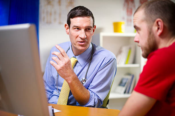 istock doctor chatting to male patient about men things 174825343