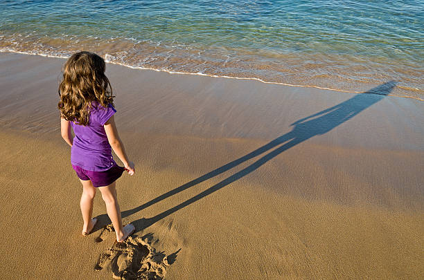 Girl Standing on Beach stock photo