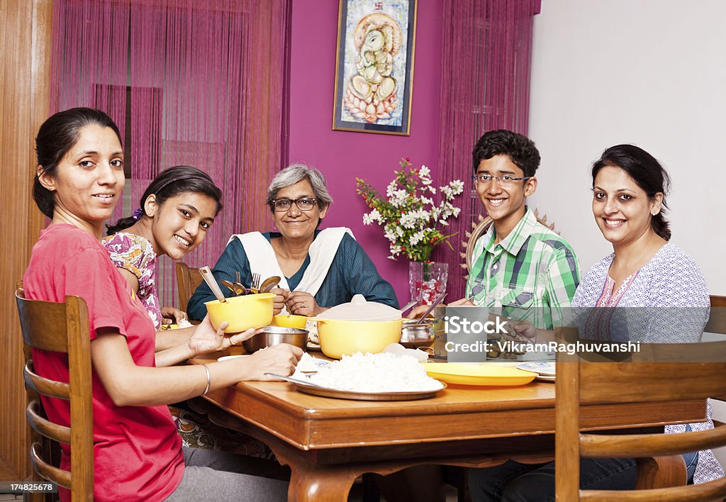 Cheerful Asian Indian Family Enjoying Meal Together Please have a look at my Managed Lightboxes. Indian Ethnicity Stock Photo