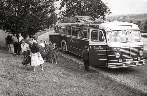 Franconia (unfortunately the exact location is not known), southern Germany, 1956. Students from a high school class from Berlin taking a break from driving. Also: a touring bus.