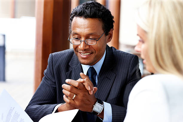 istock Smiling businessman working with female colleague 174825912