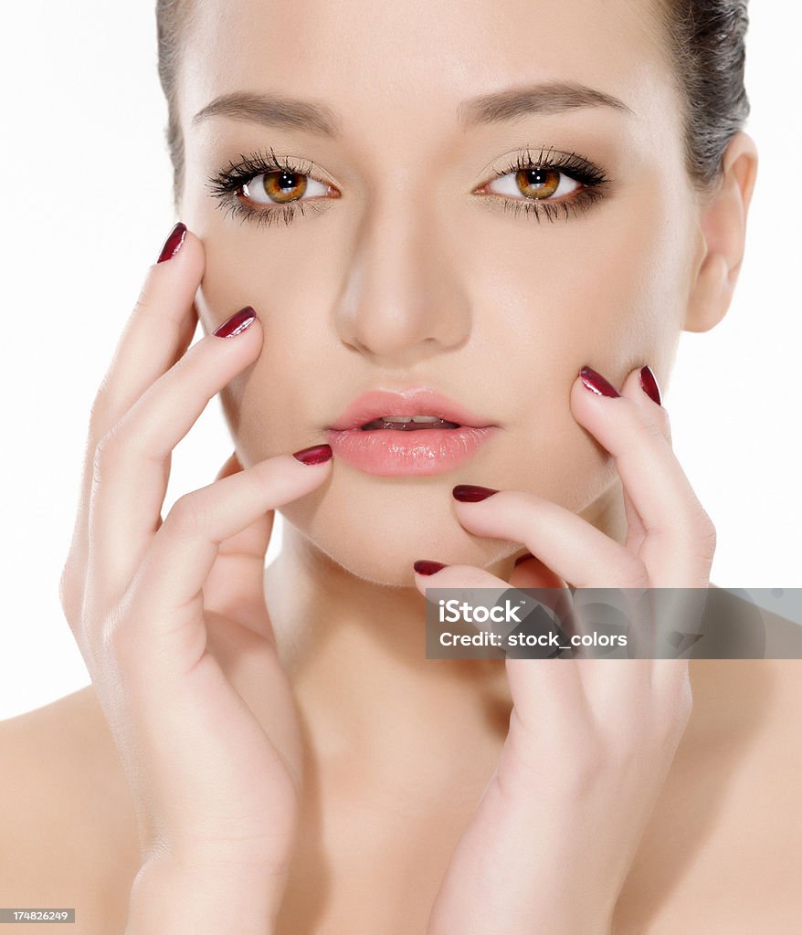 beauty touching face young beautiful woman touching face and posing, white background. 20-24 Years Stock Photo